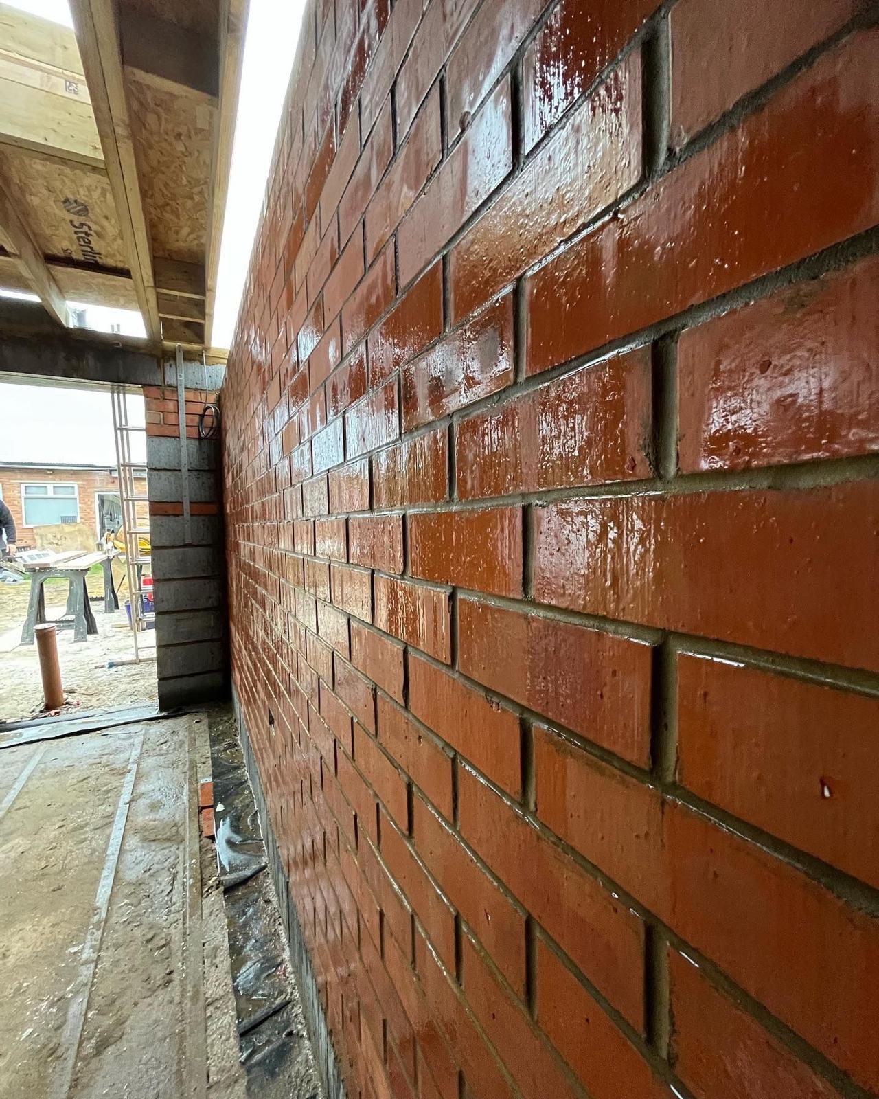 Pointing in progress on red brickwork